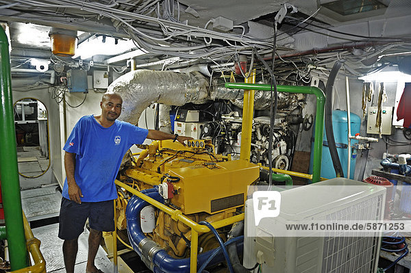 Machinist working in the engine room of a ship  Okeanoss Aggressor  Costa Rica  Central America