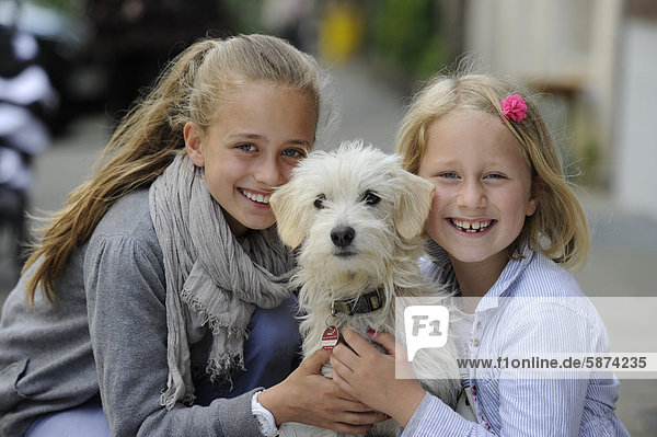 Two girls with a mixed breed puppy