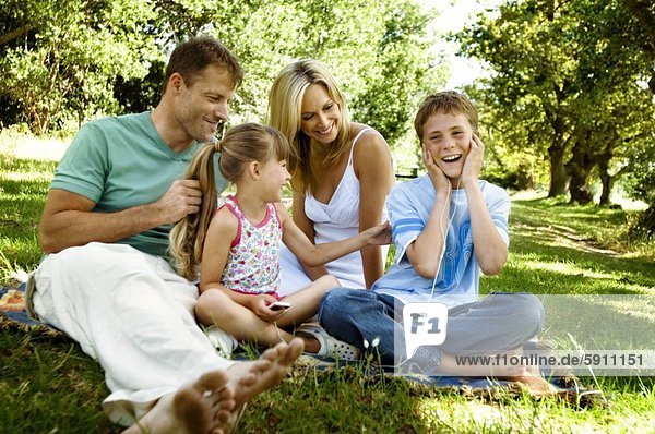 Mid adult couple with their children at a picnic