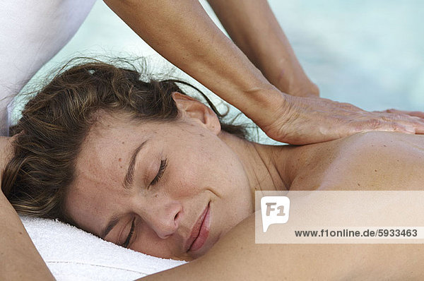 Close-up of a mid adult woman getting a back massage. Close-up of a mid adult woman getting a back massage