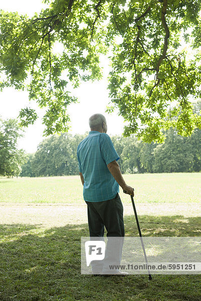 Old man standing on meadow