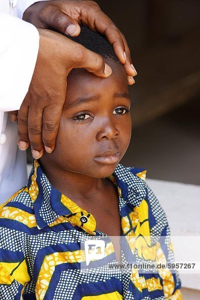 African child blessed by a priest  Lome  Togo  West Africa  Africa
