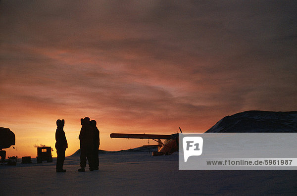 Single engined aircraft on ice at sunset  Antarctica  Polar Regions