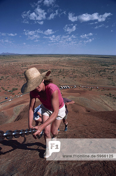 Tourist climbing Ayers Rock  Uluru-Kata Tjuta National Park  Northern Territory  Australia  Pacific