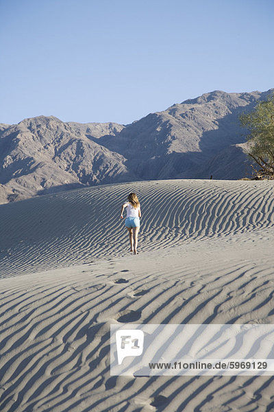 Woman jogging  Sand Dunes Point  Death Valley National Park  California  United States of America  North America