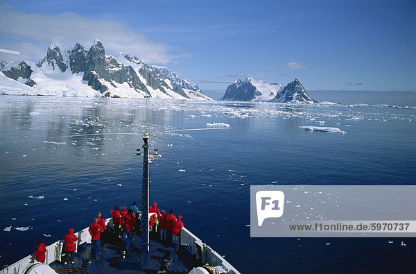 Tourists on the bow of a cruise ship off the Antarctic Peninsula  Antarctica  Polar Regions