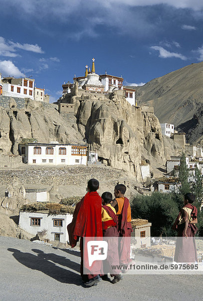 Novice monks walk from village  Lamayuru monastery  Ladakh  India  Asia
