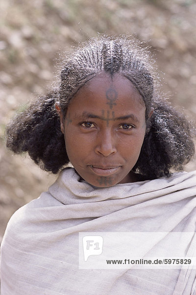 Head and shoulders portrait of a young Gourage woman with facial tattoo  Lasta Valley  Wollo region  Ethiopia  Africa