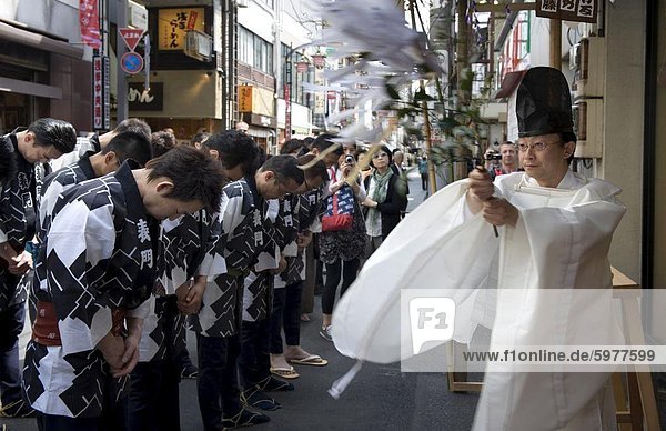 Shinto priest blessing a group of Sanja Festival participants in a religious ceremony in Asakusa  Tokyo  Japan  Asia