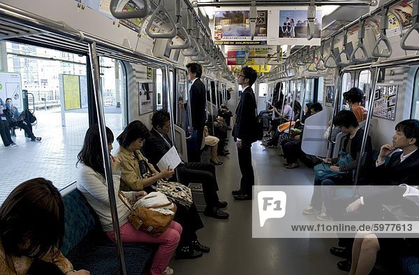 Passengers riding aboard the Yamanote loop line train that encircles greater metropolitan Tokyo  Japan  Asia