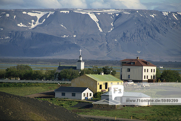 Village and church south of Lake Myvatn with hills in the background  at Skutustadir  Iceland  Polar Regions