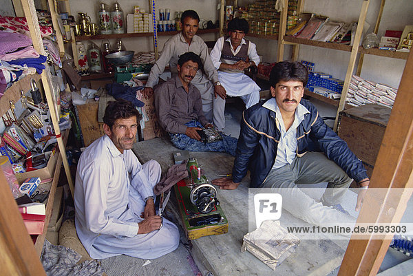 A group of men in a combined shop and workshop in Upper Hunza in the Hunza Valley  Pakistan  Asia