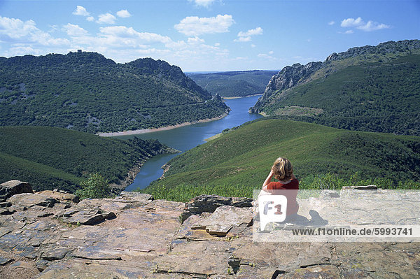 Walker at Cerro Gimio viewpoint looking to lake and hills in the Monfrague Natural Park  Caceres  Extremadura  Spain  Europe