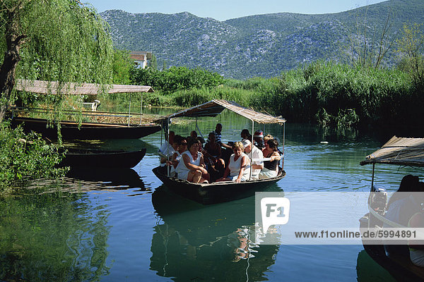 Tourists in local boats  Neretva Delta Valley  Croatia  Europe