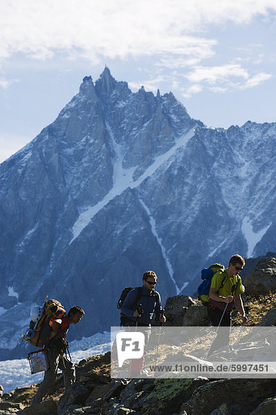Hikers on Mont Blanc against mountain backdrop of Aiguille du Midi  Chamonix  France  Europe