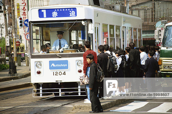 Students boarding a bus in Nagasaki  Japan  Asia
