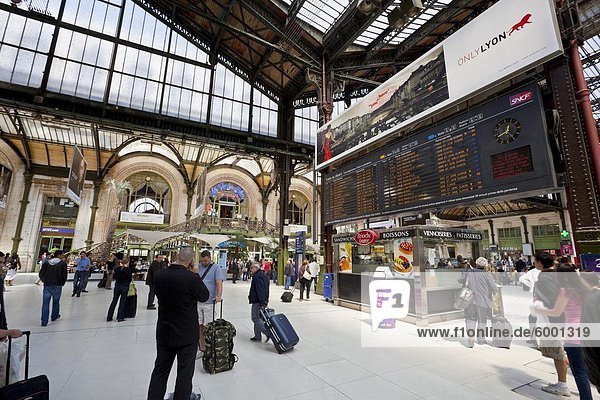 Passengers traversing through train station  by the arrival/departure board  Gare de Lyon train station  Paris  France  Europe