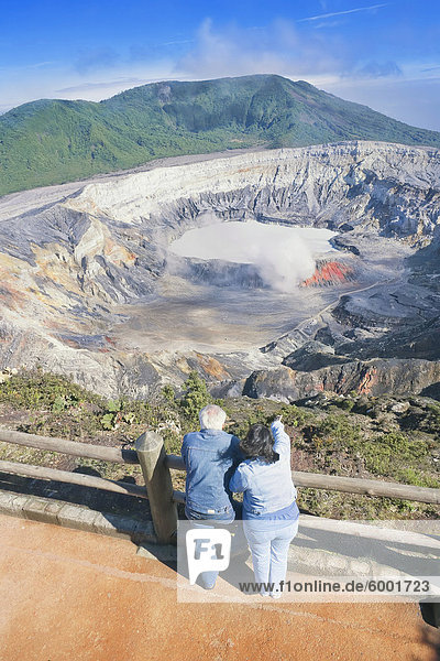 Couple looking at Poas Volcano  Poas Volcano National Park  Costa Rica  Central America