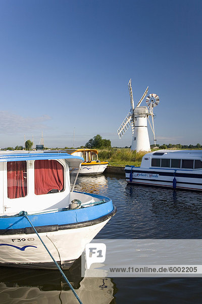 Sportboote vor Anker neben Thurne Windmühle  Norfolk Broads  Thurne  Norfolk  England  Vereinigtes Königreich  Europa