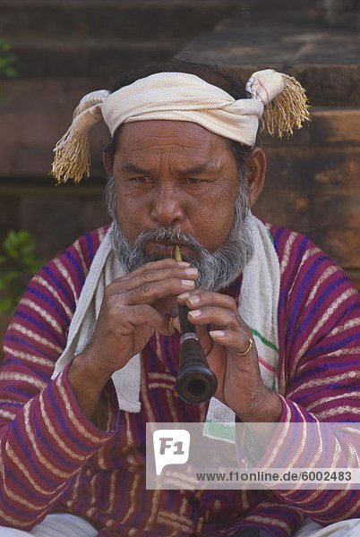 Traditionally dressed man blowing a pipe  Nha Trang  Vietnam  Indochina  Southeast Asia  Asia
