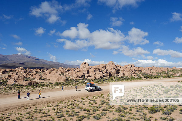 Tourists visiting rock formations in the altiplano desert  Bolivia  South America