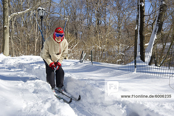 A woman on cross country skis in Central Park after a blizzard  New York City  New York State  United States of America  North America