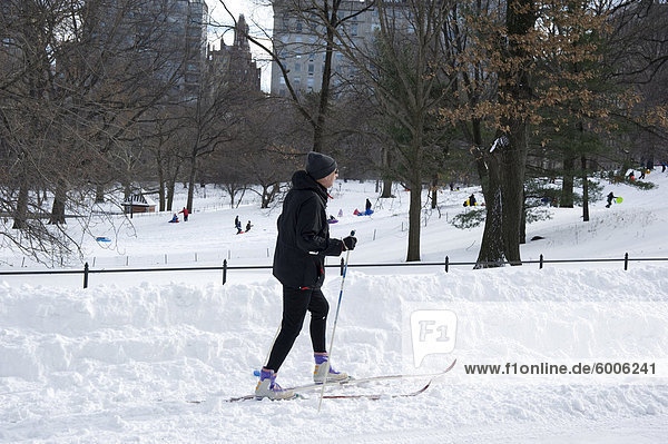 A man on cross country skis in Central Park after a blizzard  New York City  New York State  United States of America  North America