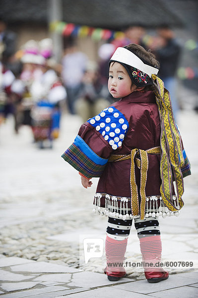 A girl in ethnic costume at a Lunar New Year festival in the Miao village of Qingman  Guizhou Province  China  Asia