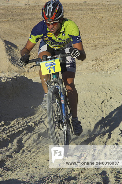 Competitior riding uphill on sandy track in the Mount Sodom International Mountain Bike Race  Dead Sea area  Israel  Middle East