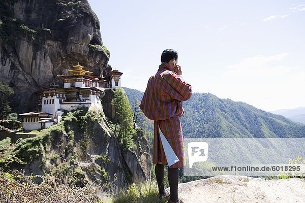 Bhutanischen Mann mit Handy  Kloster Taktsang Goemba (Tiger Nest)  Paro  Bhutan  Asien