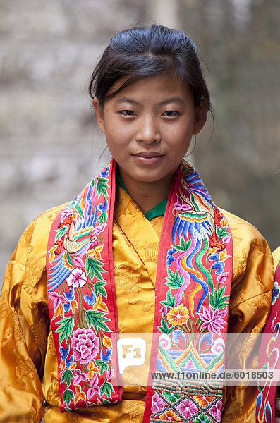 Young woman in colourful national dress at the Wangdue Phodrang Tsechu  Wangdue Phodrang Dzong  Wangdue Phodrang (Wangdi)  Bhutan  Asia
