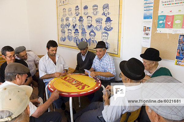 Local men play cards at Aljezur  Algarve  Portugal  Europe