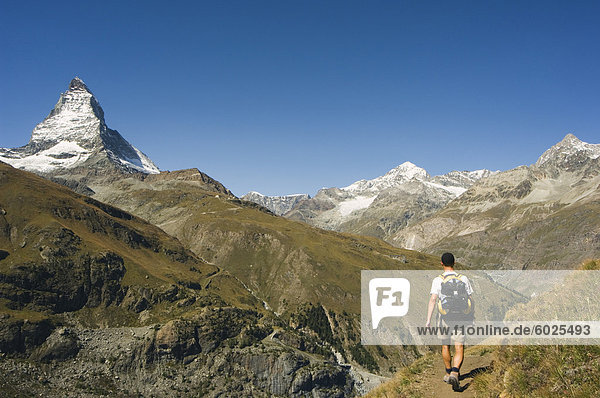 Hiker walking on trail near the Matterhorn  4477m  Zermatt Alpine Resort  Valais  Switzerland  Europe