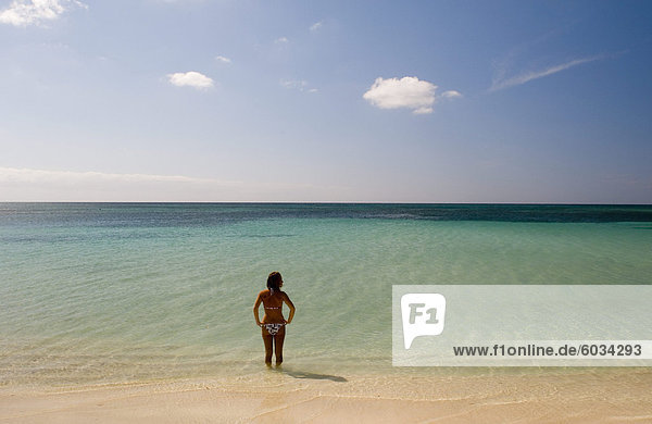 A lone woman in a bikini in the sea at Playa Ancon  Trinidad  Cuba  West Indies  Central America