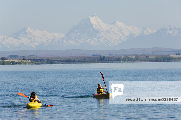 Kayaking on Lake Benmore and a distant Aoraki (Mount Cook)  3754m  Australasia's highest mountain  Southern Alps  Mackenzie Country  Otago  South Island  New Zealand  Pacific