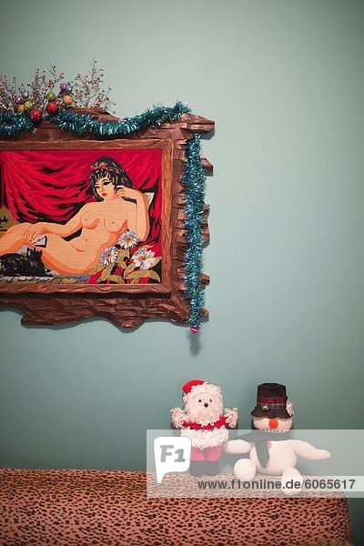Christmas decorations by picture of naked woman in living room