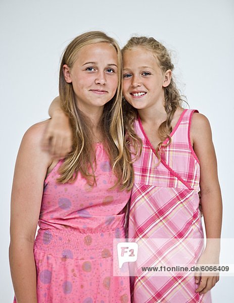 Studio portrait of two young sisters