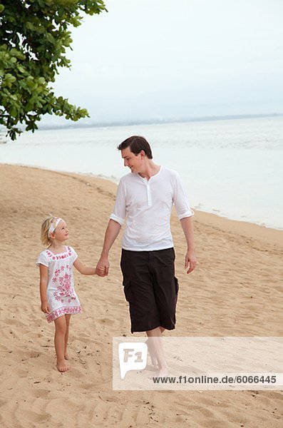 Father and daughter on beach  Bali.