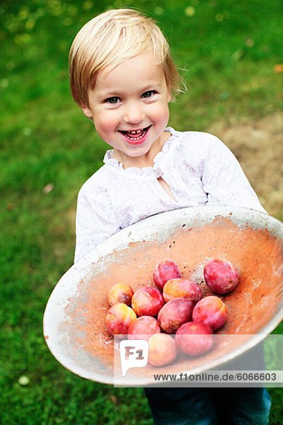 Girl holding fruits in dish
