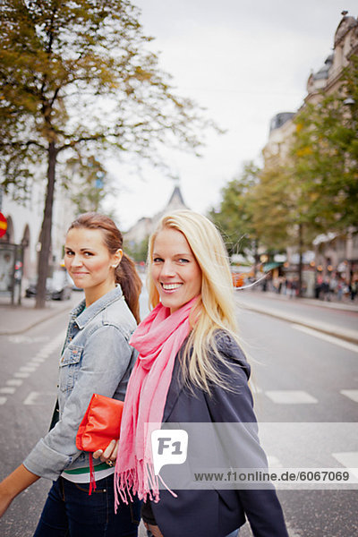 Portrait of two women walking in street