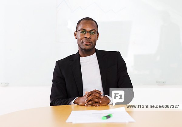 Portrait of smiling businessman sitting in office