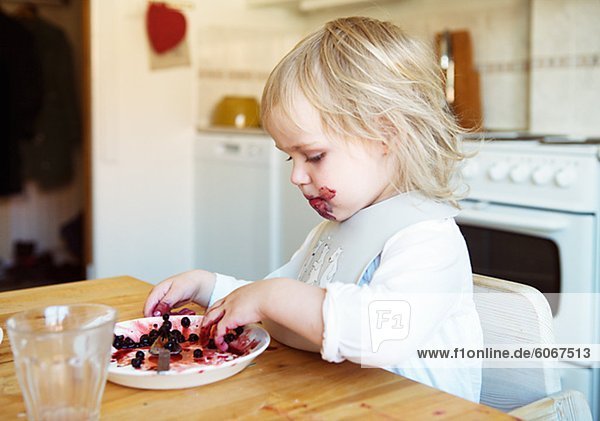 Kleine Mädchen essen Früchte in Küche