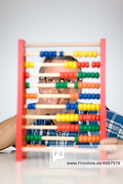 Man behind colorful abacus