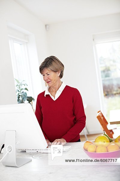 Portrait of mature woman using computer