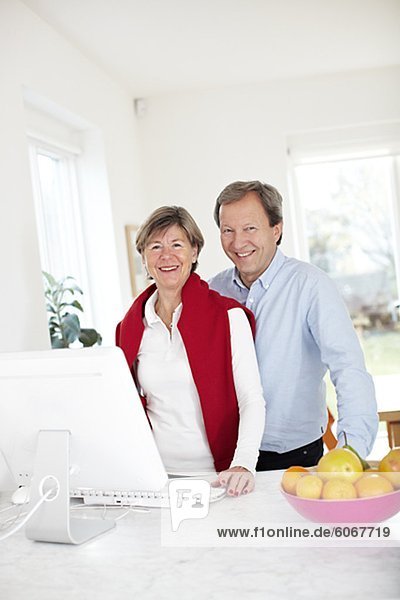 Portrait of mature couple using computer