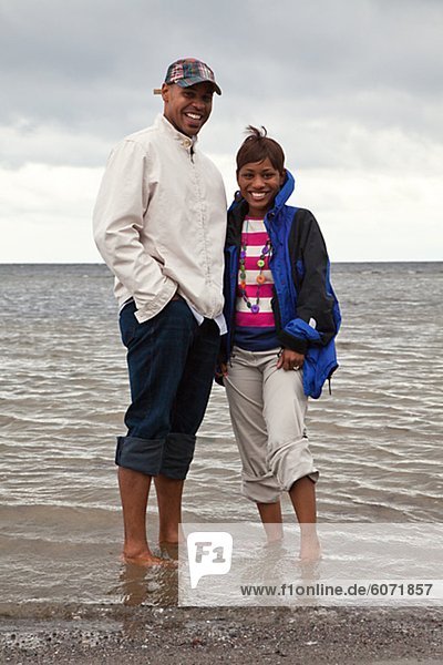 Portrait of couple wading in sea