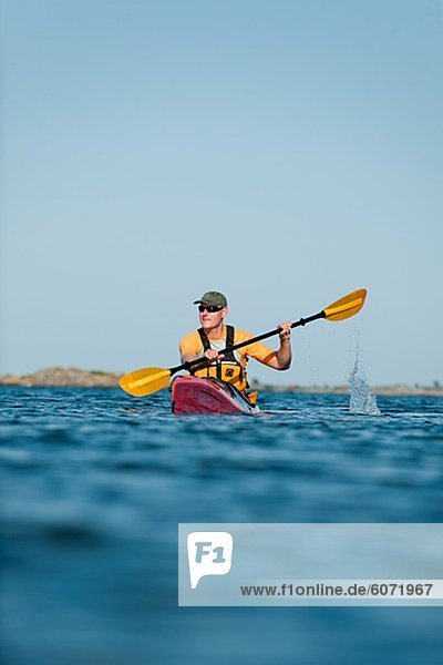Man kayaking across sea  Sweden