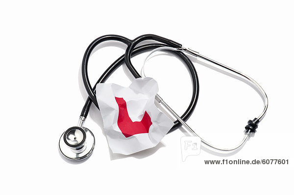 A doctors stethoscope and a crumpled learners permit sticker