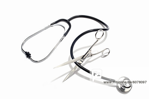 Scissors cutting through a stethoscope cable