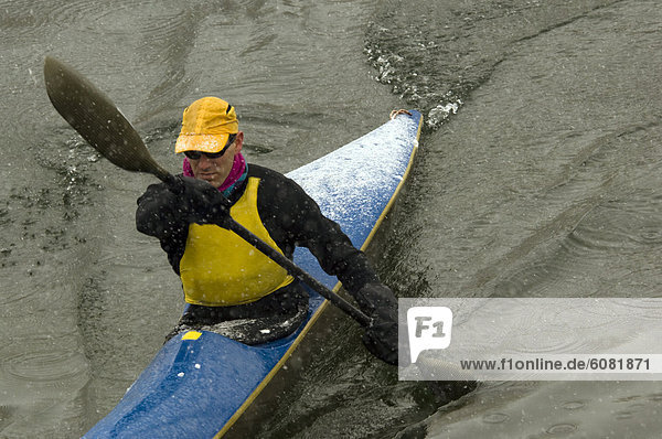 A former US National Team paddler kayaks on a river in Whitefish  MT.